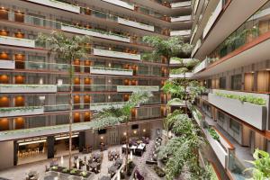 an apartment building with a courtyard with trees at Embassy Suites by Hilton Irvine Orange County Airport in Irvine