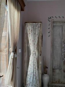 a curtain in a room next to a window at Άγρια Λούλουδα Κατοικία Ευτυχία in Timfristós +73 photos