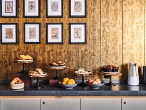 a display of different types of bread and pastries at Joinery Hotel Pittsburgh, Curio Collection by Hilton in Pittsburgh