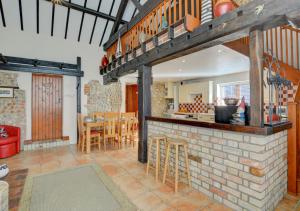 a kitchen and dining area of a home with a bar at Swallow Barn in Bodham