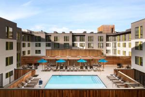 a view of a pool with chairs and umbrellas at Hilton Garden Inn Boulder in Boulder