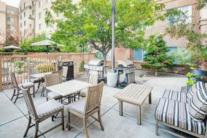 a patio with tables and chairs and a grill at Homewood Suites by Hilton Albuquerque Uptown in Albuquerque