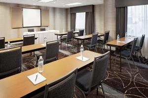 a conference room with tables and chairs and a screen at Homewood Suites by Hilton Albuquerque Uptown in Albuquerque +16 photos