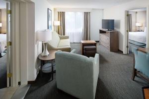 a hotel room with a bedroom with a bed and a desk at Homewood Suites by Hilton Albuquerque Uptown in Albuquerque