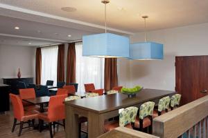 a dining room with a table and chairs at Hampton Inn Ann Arbor - North in Ann Arbor