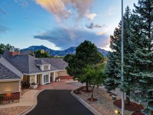 a house with a driveway and mountains in the background at Homewood Suites by Hilton Boulder in Boulder