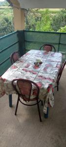 a table and chairs with a quilt on it at Shtrkovi - Storks in Petrovec