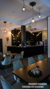 a restaurant with tables and chairs and a bar at Hotel Vegas Negreni in Negreni