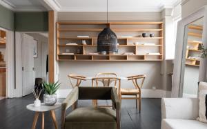 a dining room with a table and chairs at The Leicester Square Apartment By Hok Living in London
