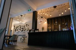 a bar in a restaurant with lights on the wall at Hotel Vegas Negreni in Negreni