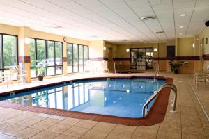 a large swimming pool in a hotel lobby with a large at Hampton Inn & Suites Bloomington Normal in Normal