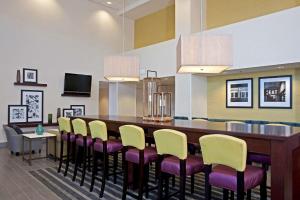 a dining room with a long table and chairs at Hampton Inn & Suites Bloomington Normal in Normal