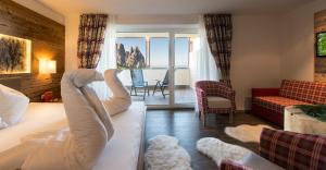 a hotel room with a bed and a view of the ocean at Hotel Chalet Dolomites in Alpe di Siusi