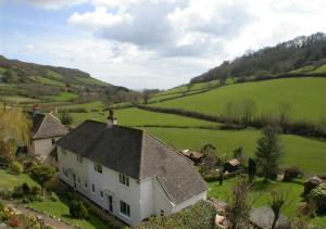 an aerial view of a house in a green field at Combe Way Cottage in Branscombe