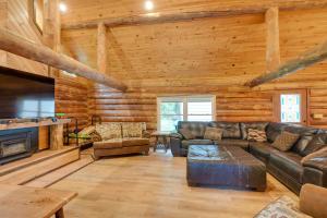 a living room with a couch and a fireplace at Secluded Greenville Cabin Walk to Moosehead Lake! in Greenville