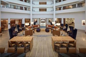 a view of a lobby with tables and chairs at Hilton Nashville Airport in Nashville