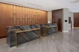 a lobby with wooden walls and a row of desks at Hilton Nashville Airport in Nashville