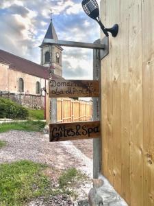 a sign on the side of a building with a church at Chez Laurette in Frémifontaine