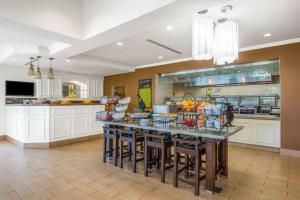 a kitchen with a large island with bar stools at Hilton Garden Inn Wichita in Wichita