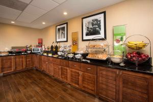 a buffet line with bowls of food and fruit at Hampton Inn Morehead City in Morehead City