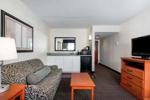 a living room with a couch and a kitchen at Hampton Inn Morehead City in Morehead City