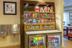 a refrigerator with drinks and a m sign on a wall at Hampton Inn Minneapolis-Burnsville in Burnsville