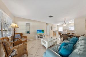 a living room with a couch and a table at Sandy Seahorse Cottage in Siesta Key