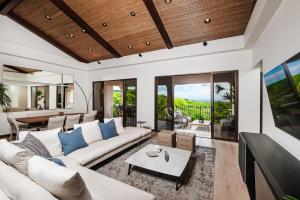 a living room with a couch and a tv at Jobo 9 Reserva Conchal in Playa Conchal