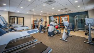 a gym with treadmills and machines in a room at DoubleTree by Hilton Hotel West Palm Beach Airport in West Palm Beach