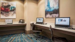 a room with two desks with computers on them at DoubleTree by Hilton Hotel West Palm Beach Airport in West Palm Beach