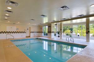a large swimming pool in a large room at Hilton Garden Inn Raleigh Durham Airport in Morrisville