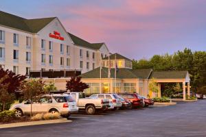 a hotel with cars parked in a parking lot at Hilton Garden Inn Springfield, IL in Springfield