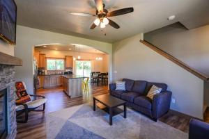 a living room with a couch and a ceiling fan at CDA Hideaway 4 bed 3 Bath Modern Mid Term Rental in Hayden +23 photos