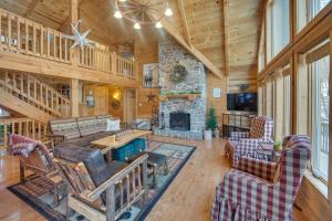 a living room with a stone fireplace in a log cabin at Grand 4,000 Sq Ft House - 11 Miles to Lancaster! in New Providence