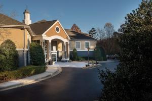 a house with a driveway in front of it at Homewood Suites by Hilton Raleigh/Cary in Cary