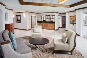 a living room with chairs and a table at Homewood Suites by Hilton Raleigh/Cary in Cary