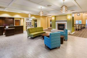 a lobby of a hospital with chairs and a fireplace at Homewood Suites by Hilton St. Louis Riverport- Airport West in Maryland Heights
