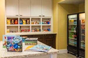 a kitchen with a counter and a refrigerator with food at Homewood Suites by Hilton St. Louis Riverport- Airport West in Maryland Heights