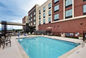 a swimming pool in front of a building at Hilton Garden Inn Madison Huntsville Airport in Madison