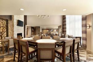 a dining room with a large table and chairs at Homewood Suites by Hilton Portland Airport in Portland