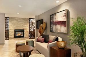 a living room with a couch and a fireplace at Homewood Suites by Hilton Portland Airport in Portland