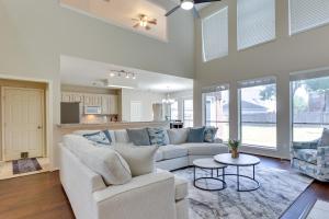a living room with a couch and a table at Spacious Sugar Land Retreat with Fireplace and Yard in Sugar Land