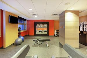 a waiting room with a gym with chairs and a television at Home2 Suites by Hilton San Antonio Downtown - Riverwalk, TX in San Antonio