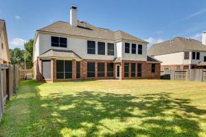 a house with a large yard with a fence at Spacious Sugar Land Retreat with Fireplace and Yard in Sugar Land