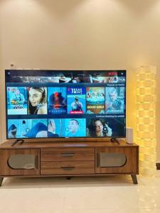 a flat screen tv sitting on top of a wooden entertainment center at ستوديو البوليفارد مدخل جانبي h3 in Riyadh