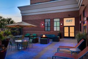 a patio with tables and chairs in front of a building at Hilton Richmond Hotel & Spa Short Pump in Richmond