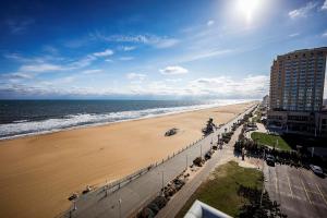 a view of a beach with a building and the ocean at Hampton Inn Virginia Beach Oceanfront North in Virginia Beach