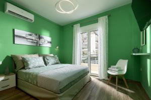 a green bedroom with a bed and a window at Domenico Homes - City Center in Heraklio Town