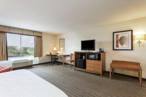 a hotel room with a bed a desk and a tv at Hampton Inn Petersburg - Southpark Mall in Colonial Heights