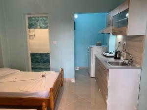 a small kitchen with a bed and a sink at VILLA STATHIS in Nea Vrasna +71 photos